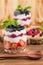 Trifle close up photography with fresh multi layered dessert with dairy and ripe raspberries and blackberries.
