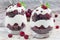 Trifle dessert with brownie, cream cheese frosting and raspberry in glass, horizontal