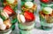 Trifles in plastic glasses with fresh fruit and cream.