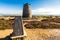 Trig point with derelict windmill, Parys Mountain.