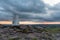 Trig point on top of The Roaches at sunset in the Peak District National Park