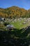 Triglav autumn larches and wooden houses