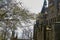 Trimmed side view of Marienburg Palace with protruding branches of trees at the side