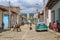 Trinidad, Cuba-November 15,2017. Street urban scene with old car and colorful Cuban houses.American classic car and lifestyle in