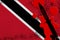 Trinidad and Tobago flag and black tactical knife in red blood. Concept for terror attack or military operations with lethal