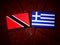 Trinidad and Tobago flag with Greek flag on a tree stump isolate