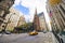 Trinity Church in Manhattan and street with tourists and traffic
