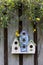 Trio of birdhouses with spring flowers.