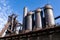 Trio of blast furnaces in an abandoned steel mill industrial plant, brilliant blue sky and clear morning light