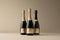 Trio of champagne bottles with a neutral backdrop