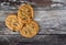 Trio of choc chip cookies seen fresh from the oven, on a rustic kitchen table.