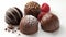 A trio of decadent chocolate truffles in flavors of dark chocolate salted caramel and raspberry