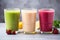 trio of different colored smoothies in glasses