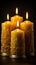 Trio of flickering candles standing alone against a black backdrop