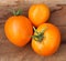 A Trio of Freshly-Picked Orange Tomatoes