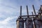 Trio of old blast furnaces and stacks against a blue sky with clouds