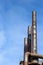 Trio of smoke stacks in an old industrial site, bright blue sky copy space