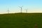A trio of wind turbine silhouettes at dawn
