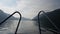 A trip on a fast boat on lake Teletskoye in Russia. View of the evening mountains in the haze.