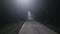 A trip on a rural forest road in a fog at night