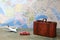 Trip or traveling by airplane concept. Miniature toy airplane and suitcases on map.