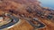 Trip truck curved road in mountains view drone. Delivery car background ocean 4K