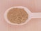 Triphala organic powder in wooden spoon