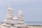 Triple balance tower white grey pebble on a beach