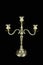 Triple bronze vintage candelabrum with three candlesticks on black background