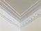 Triple lines and stage opening curtain shaped crown molding in expensive home ceiling at the corner ornamental.