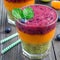 Triple smoothie in glass: kiwi mint, mandarin apricot and strawberry blueberry, square