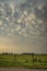 Tripods with equipment belonging to storm chasers below a thundery sky with mammatus clouds on the great plains.