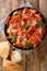 Trippa alla Romana Roman Style tripe with tomato sauce closeup in the plate. Vertical top view