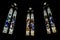 Triptych of stained-glass windows from St Patrick`s Cathedral on black background in Melbourne Australia