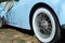 Triumph sports car closeup with white wall tire