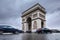 Triumphal arch. Arc de triomphe. View of Place Charles de Gaulle. Famous touristic architecture landmark in rainy day. Long expos