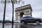 Triumphal arch. Arc de triomphe. View of Place Charles de Gaulle. Famous touristic architecture landmark in rainy day. Long expos