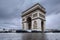 Triumphal arch. Arc de triomphe. View of Place Charles de Gaulle. Famous touristic architecture landmark in rainy day. Long expos