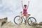 Triumphant Woman On Hilltop With Mountain Bike