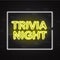 Trivia night yellow neon sign in white frame on dark brick wall background.