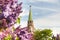 Troitskaya Tower of the Moscow Kremlin and blurred lilac branches in Moscow, Russia