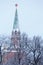 Troitskaya Trinity tower of Moscow Kremlin, topped with a red star, view through winter park