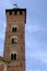 Trojan Tower of Asti. The tall tower, also known as the clock tower, is built in red terracotta bricks.  It has mullioned windows