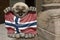 Troll figure holding a flag in front of a souvenir shop in Alesund, Norway. Troll is a class of being in Norse mythology and