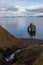 Troll rock in Iceland stands in the sea