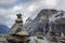 Troll rock pyramid with rainbow on top of Trollstigen road. Stone cairn