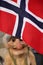 Troll statue which is traditional Norwegian folklore standing under the flag of Norway.