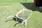 Trolley for concrete filled with mowed grass. rakes and rubber gloves,
