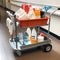 Trolley with detergents of a cleaning company worker, a janitor, isolated on a white