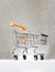 Trolley for shopping on a pedestal on a silver background with a glow. Best Buyer, Best Buy.